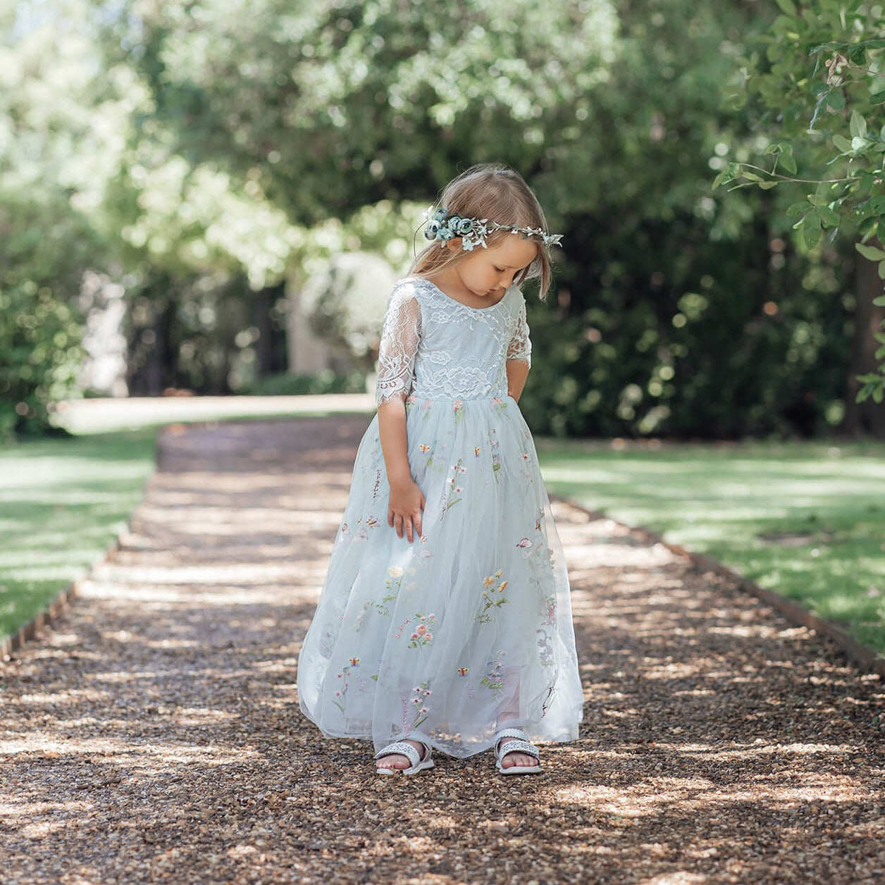 Beautiful flower girl wearing baby blue dress