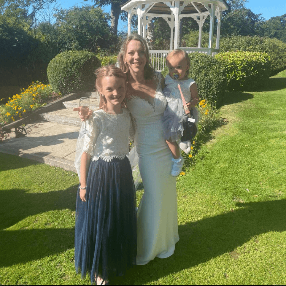 Bride and flower girl in gardens