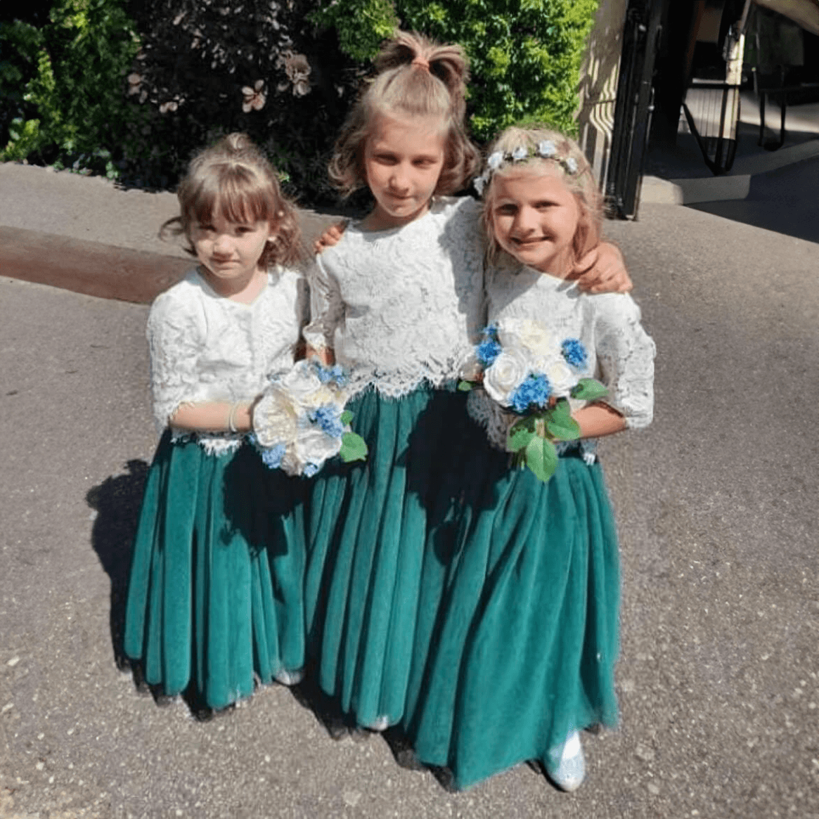 Young children holding bouquets 