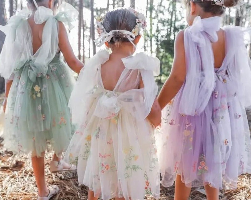 3 young girls wearing pretty dresses