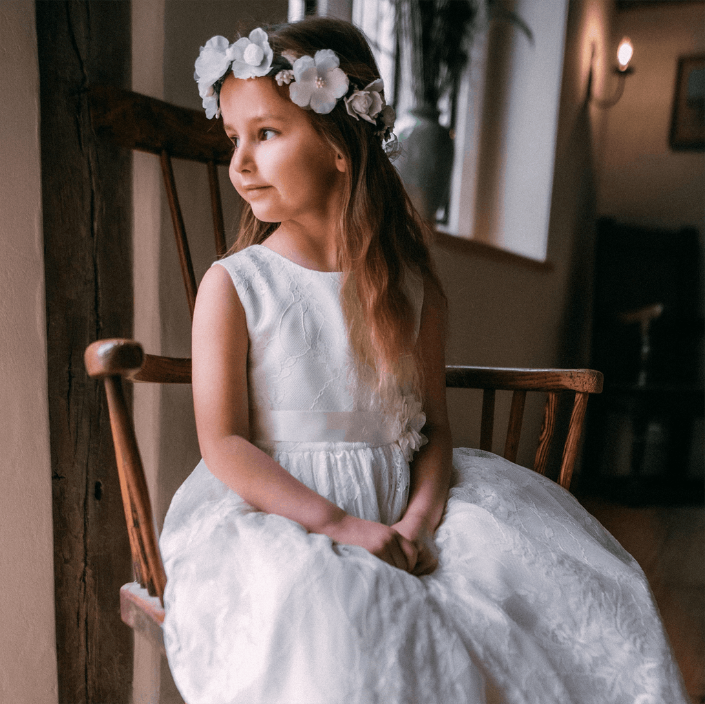 Young girl wearing a Lilliana Dress in Ivory  