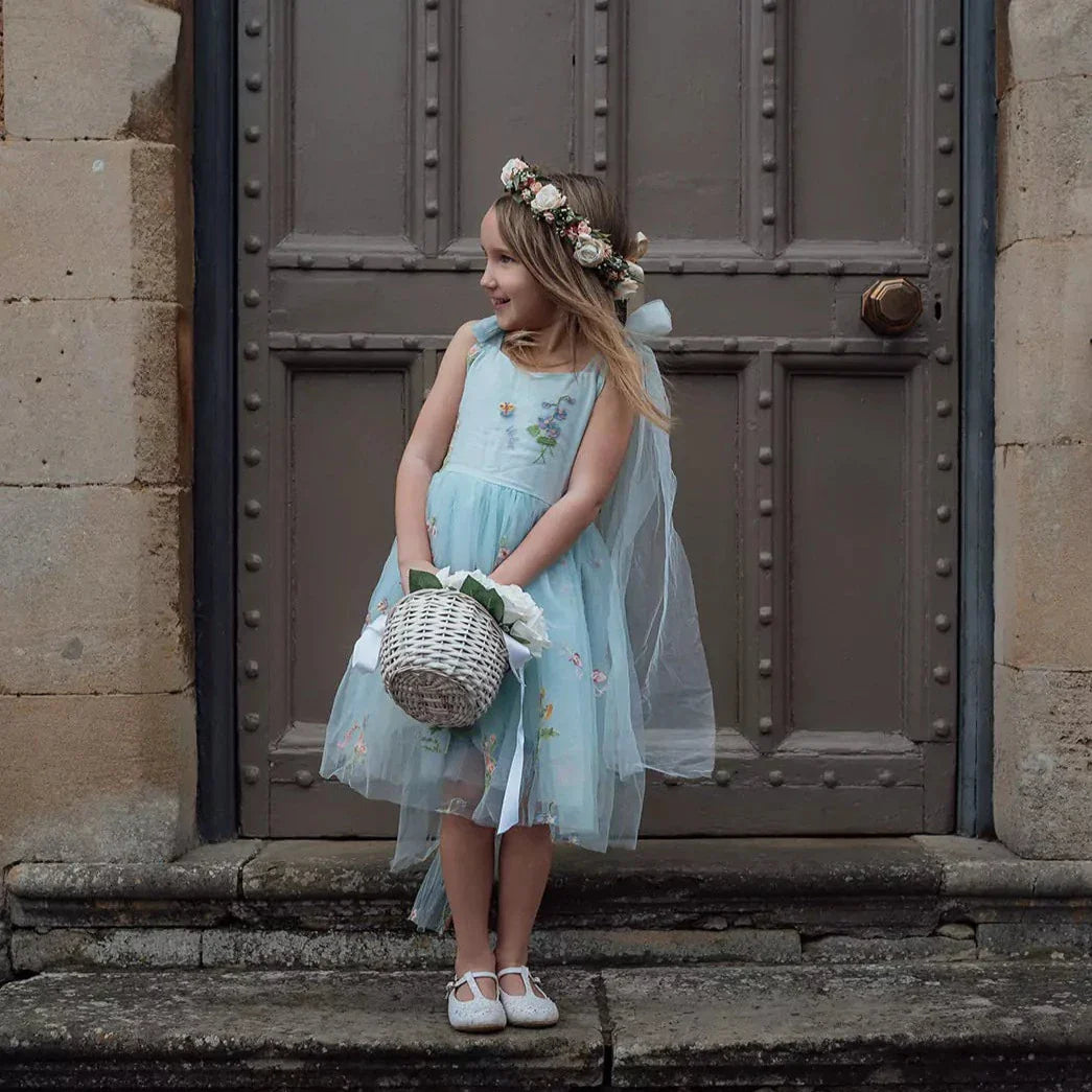 Flower girl holding basket looking to left