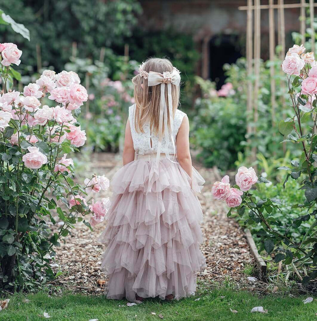 Young child walking through flower garden