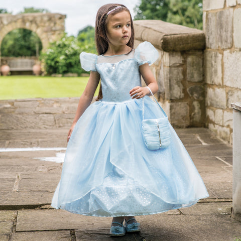 Girl in a garden wearing a blue Shimmer Princess Dress